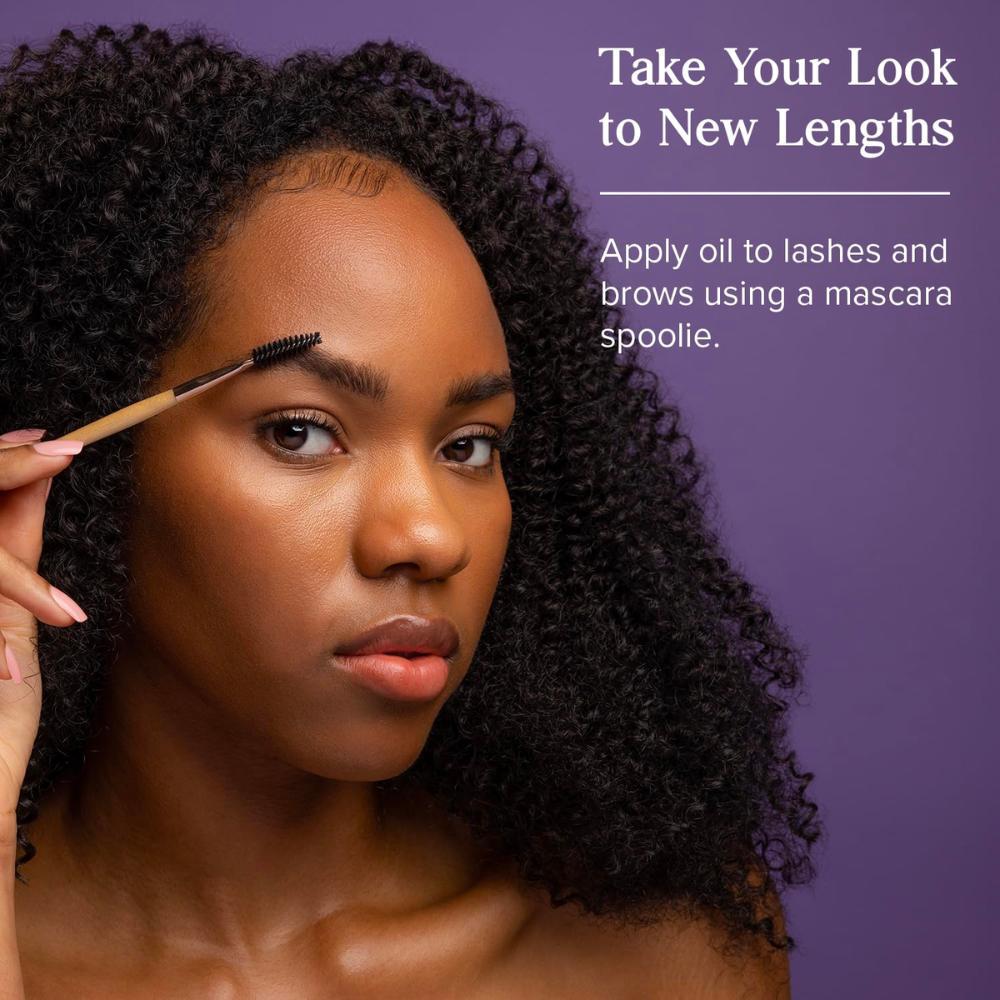 Woman using spoolie to apply castor oil to eyebrows. Take your look to new lengths. Apply oil to lashes and brows using a mascara spoolie.